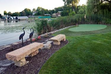 stone benches and putting green overlooking lake minnetonka