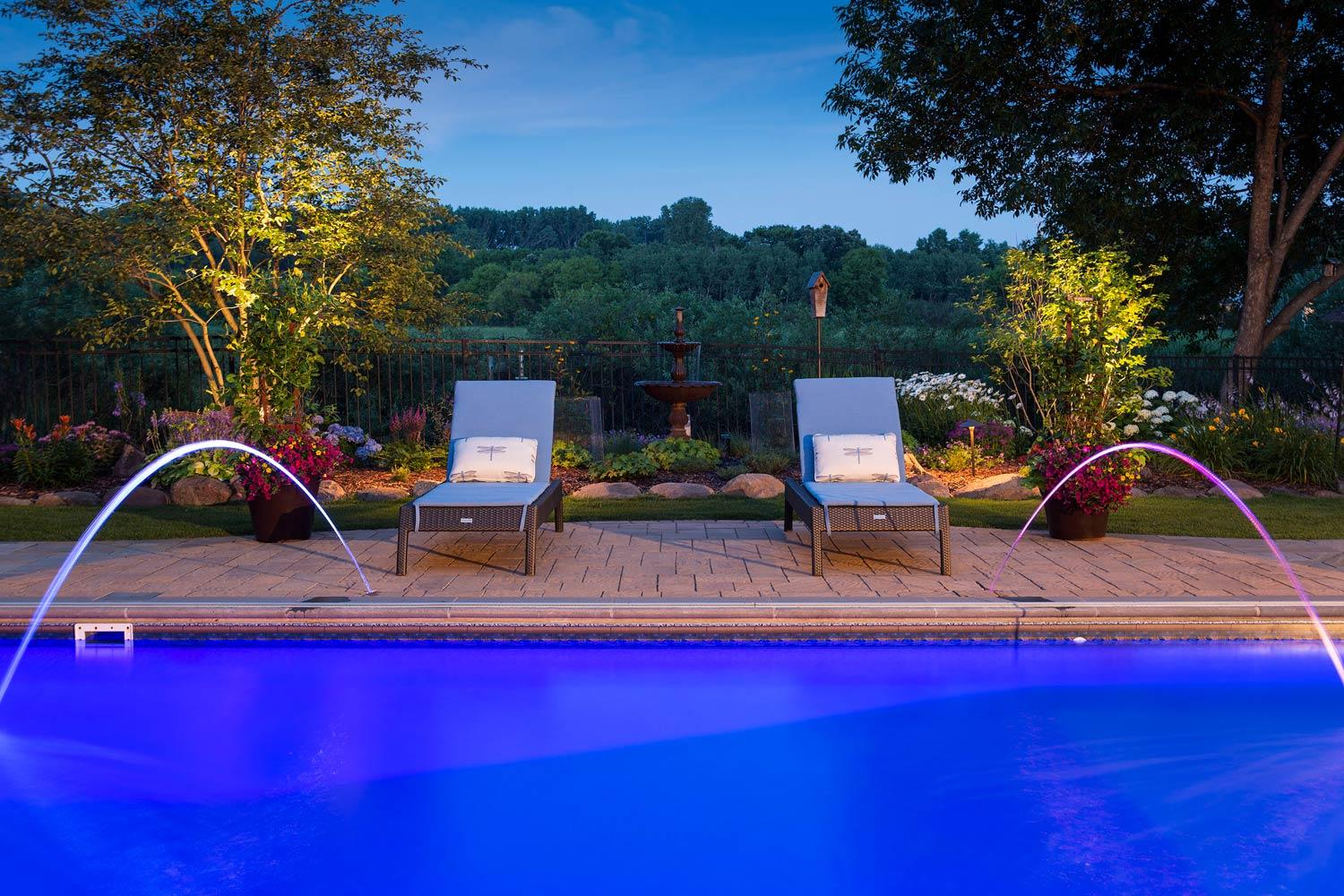 Backyard swimming pool with laminar jets and LED lighting