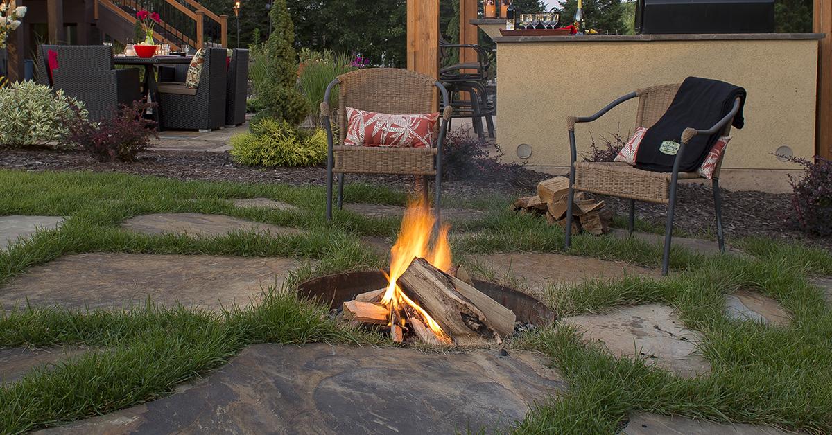 wood-burning fire pit tucked in giant flagstone