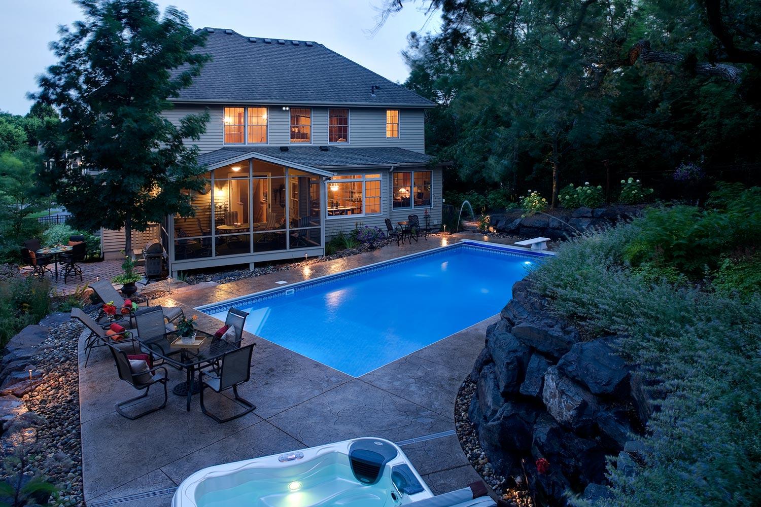 backyard swimming pool on a hill in a suburban backyard