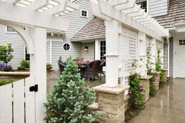 Custom-designed white trellis separated the driveway from the dining patio