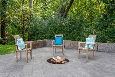 in ground wood-burning fire pit with 45 degree diagonal pavers and missouri ledgestone seat wall