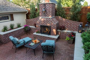 Red brick backyard fireplace and patio in St. Paul MN