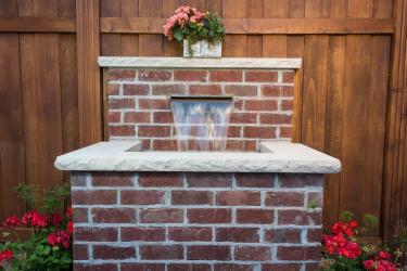 French Quarter-inspired backyard water fall feature design