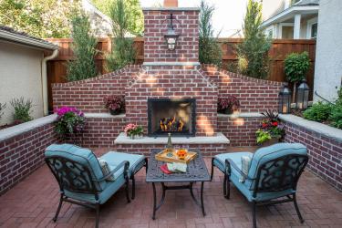 Centered on a hand-build re brick fireplace and two aqua blue outdoor chez lounge chairs