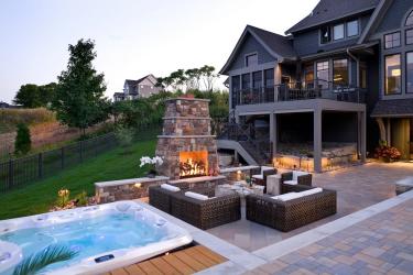 sitting patio with fireplace and hot tub
