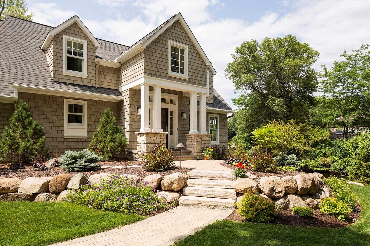 suburban front entry design that uses boulder and natural elements