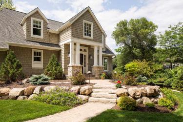suburban front entry design that uses boulder and natural elements