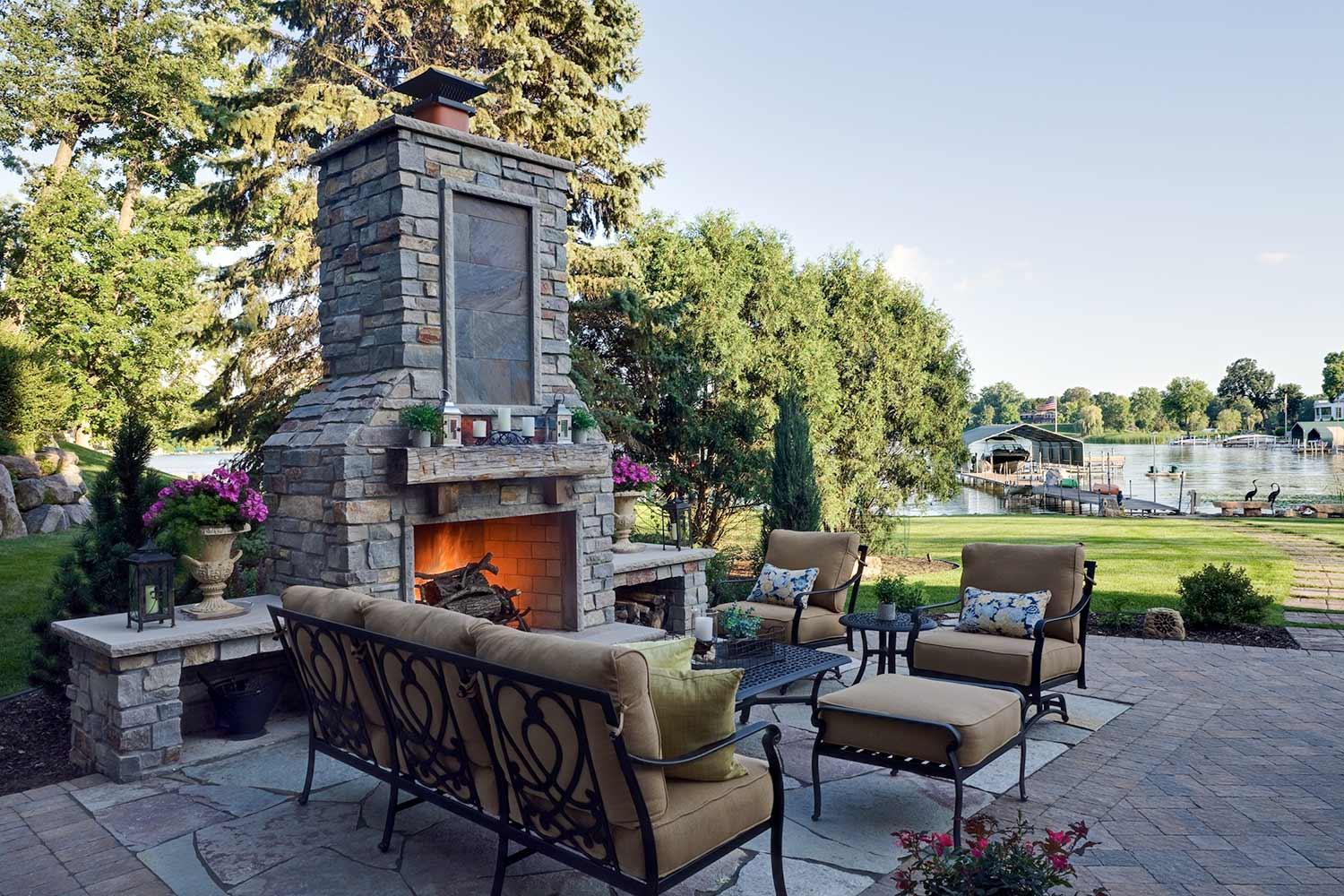 cottage stone backyard fireplace and custom paver patio design