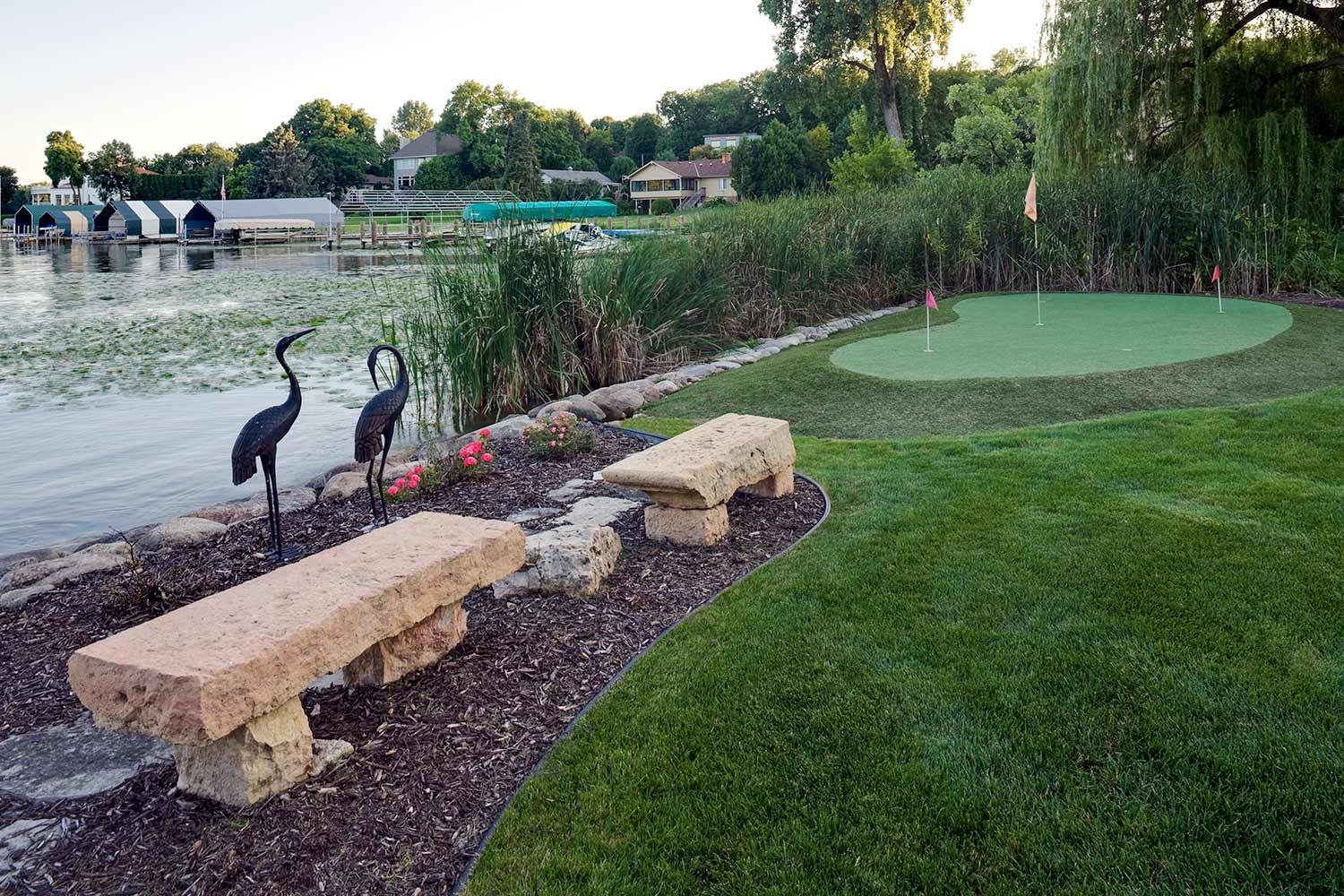 stone benches and putting green overlooking lake minnetonka