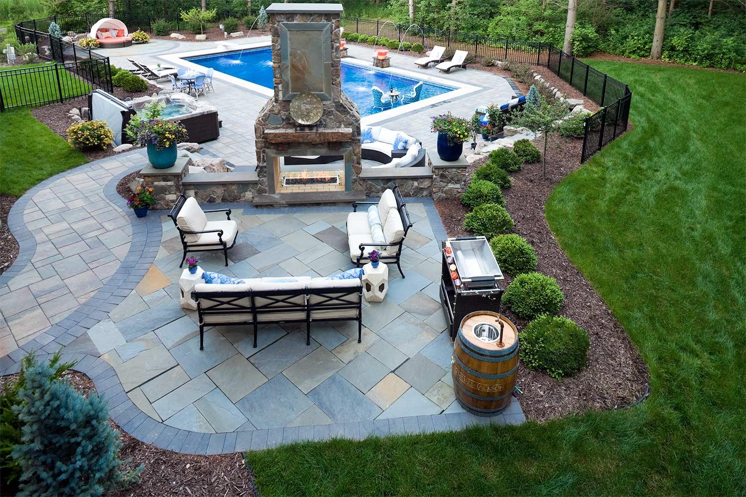 Bluestone patio with statement fireplace and unique bar set.