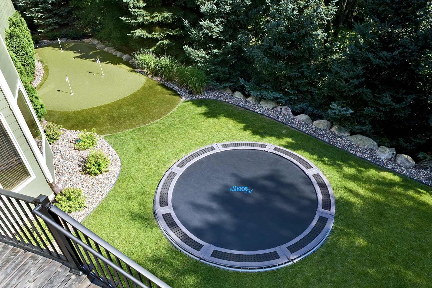 Backyard in-ground trampoline and putting green