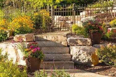 Stone steps and walkways provide safe, easy access to the backyard swimming pool