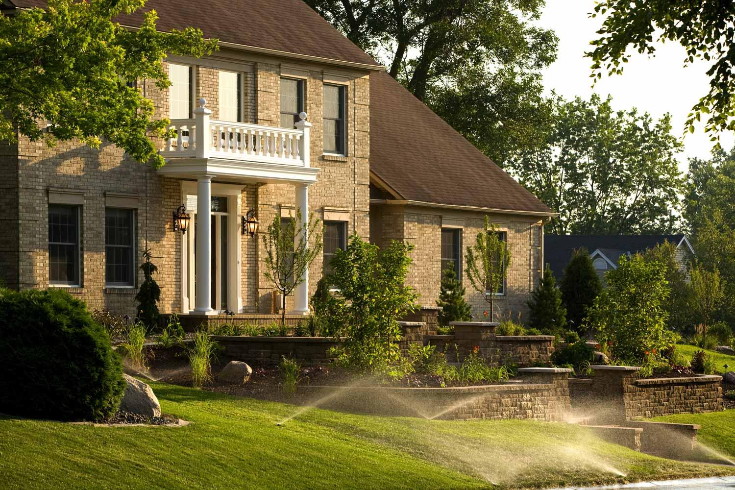 Traditional Brick Home with Retaining Walls and Irrigation System