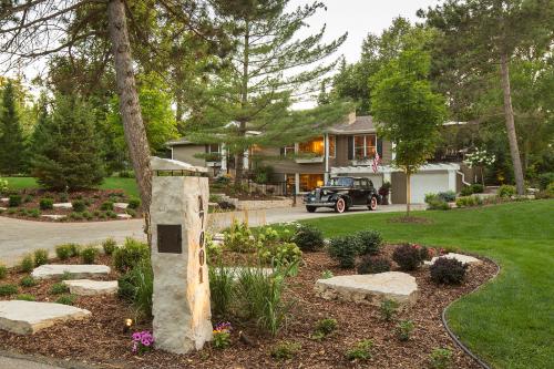 Stone Mailbox with LED lighting Surrounded by Shrubs and Perennials