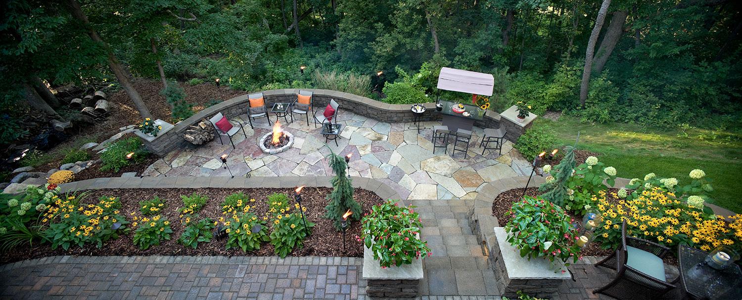Natural Stone Patio and Fire Pit Landscaping on a Hill