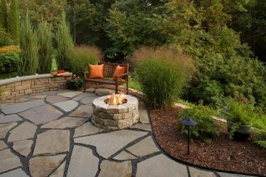 Natural stone fire pit and patio on the edge of a gorge.