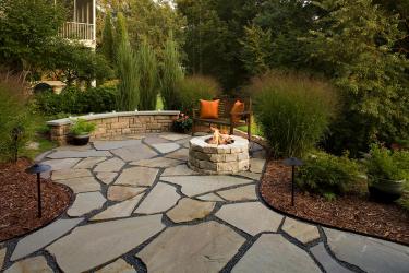 Stone patio and fireplace in Golden Valley, MN backyard landscape