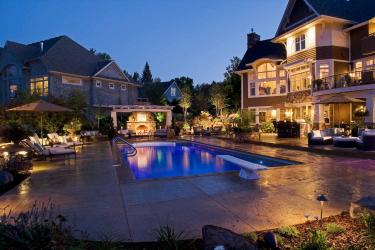 Luxury backyard lit up at night