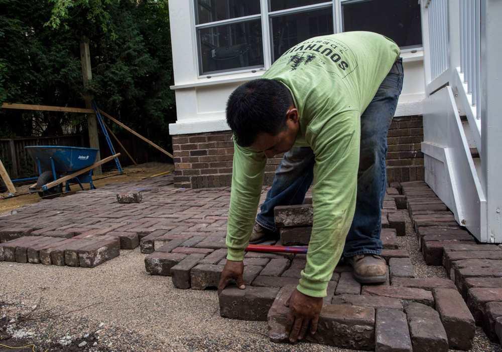 Southview design crew installing and herringbone brick patio in Minneapolis Metro Area