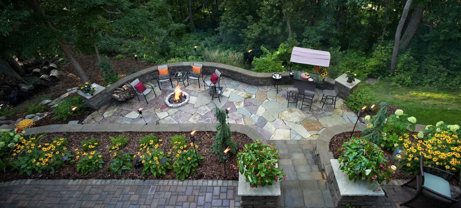 Northwoods style multi-level natural stone and paver patios. Minneapolis Metro Area