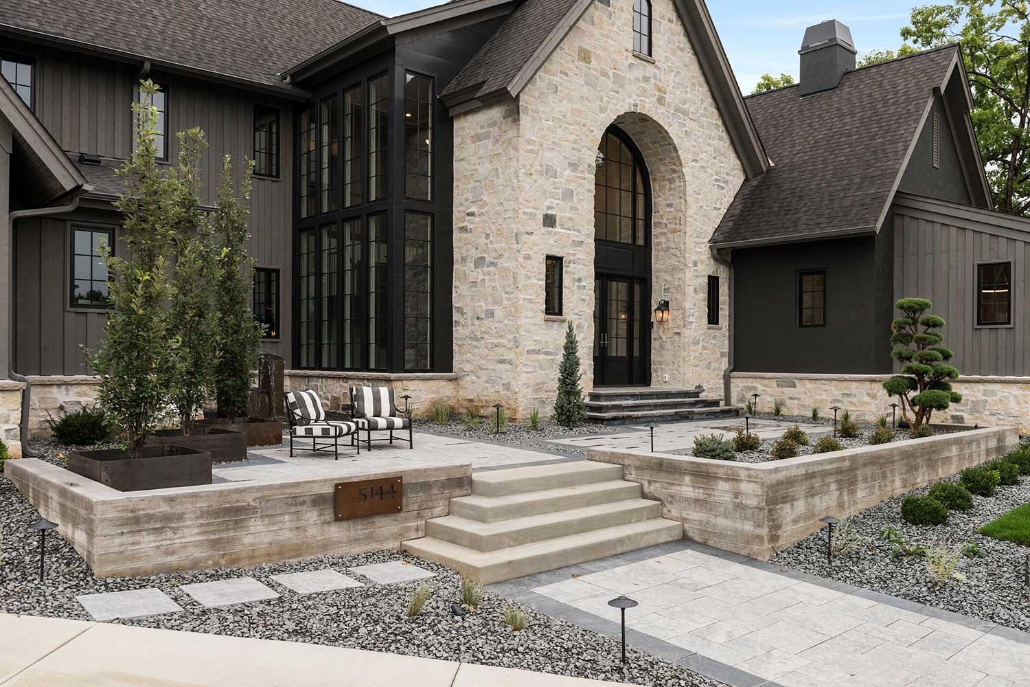 modern meets rustic front entry design with sitting patio