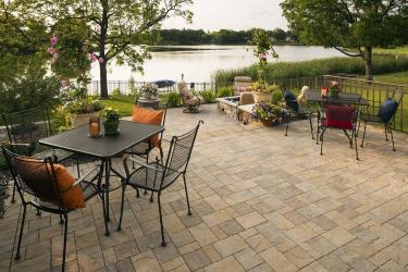 multi-level backyard patio with room for furniture and a fire table by the lake in edina, MN