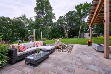 Sitting patio with large format pavers and a brick paver border.