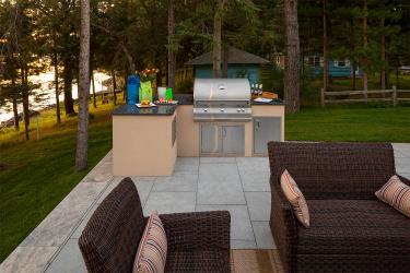 Basic outdoor cooking station with built-in natural gas grill, storage, and a solid countertop.