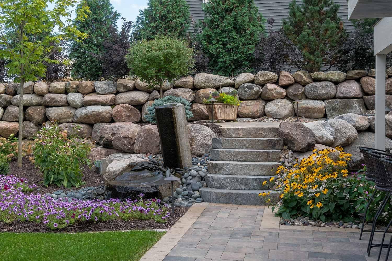 stone steps path boulder wall and garden