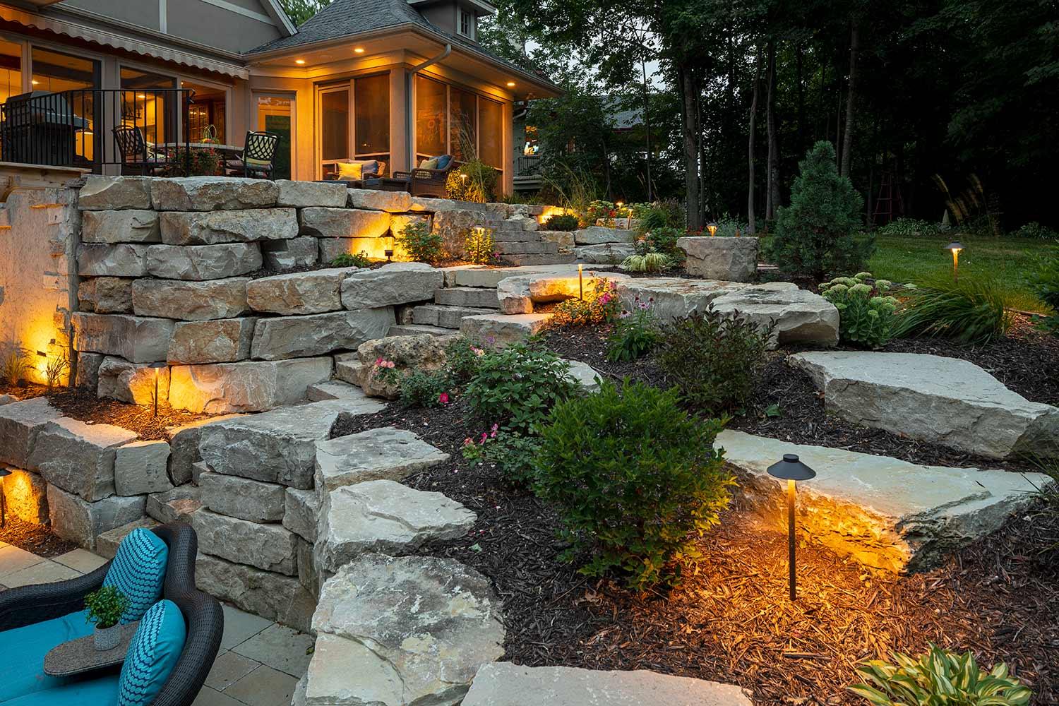natural stone retaining wall and outdoor lighting