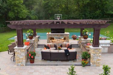 outdoor living room with pergola and statement open fireplace