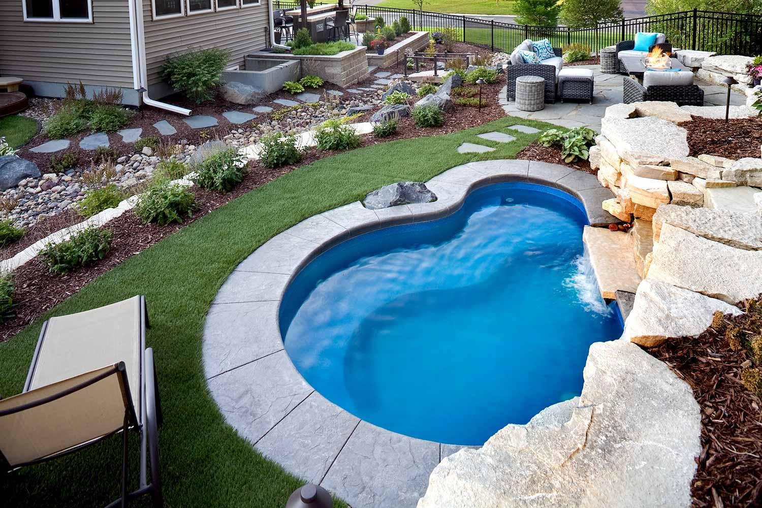 Small plunge pool surrounded by artificial turf.