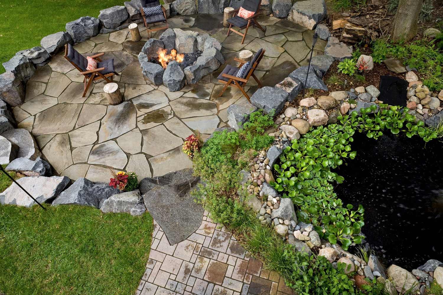 aerial view of the fish pond, natural stone patio, and paver walkway