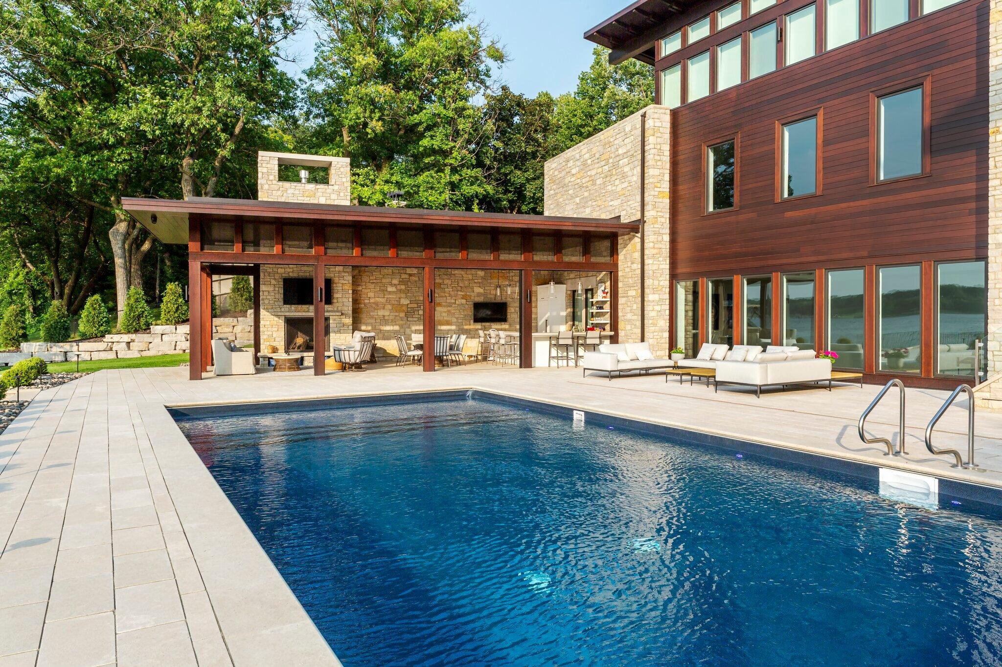 swimmming pool with covered outdoor kitchen and fireplace