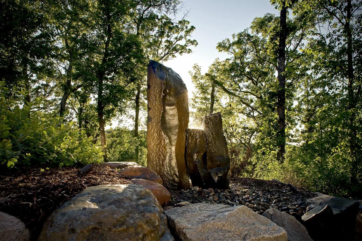 Three stone pillars make an organic, natural water feature