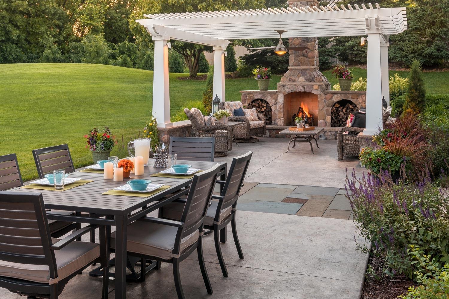 Outdoor backyard living and dining room patios with bluestone pathway.