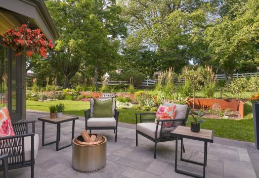 Backyard patio made with Belgard pavers and corten steel garden beds