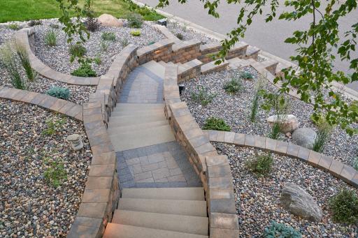 belgard retaining walls with rock beds and low maintenance plants