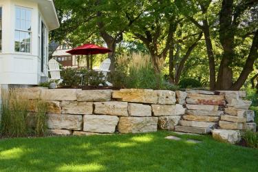 Stacked stone boulder retaining wall.