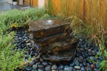 Stacked stone bubbler fountain water feature.
