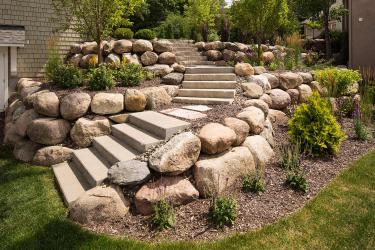 Concrete steps and boulder wall