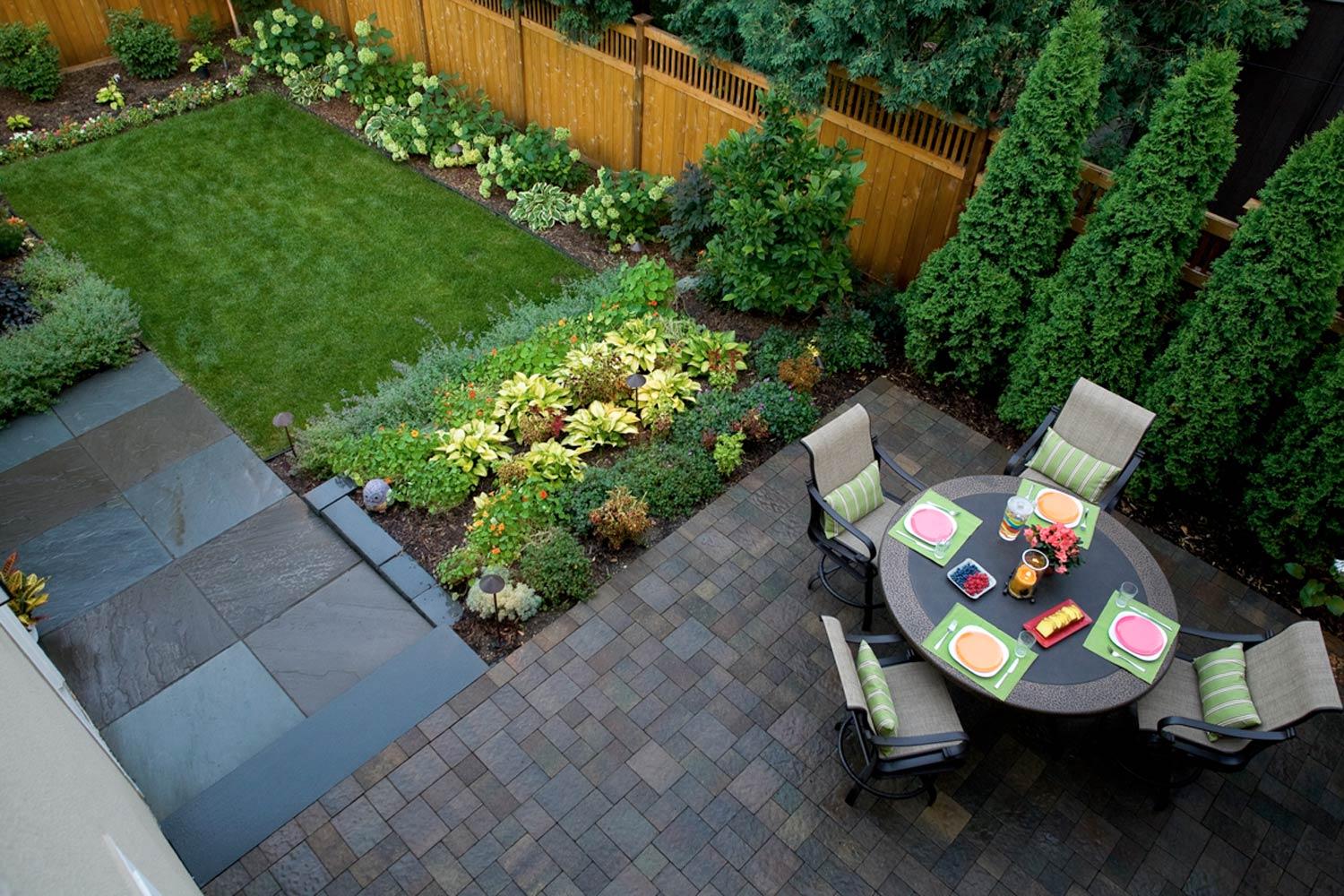 Contemporary formal backyard with edible and decorative plants in the garden.