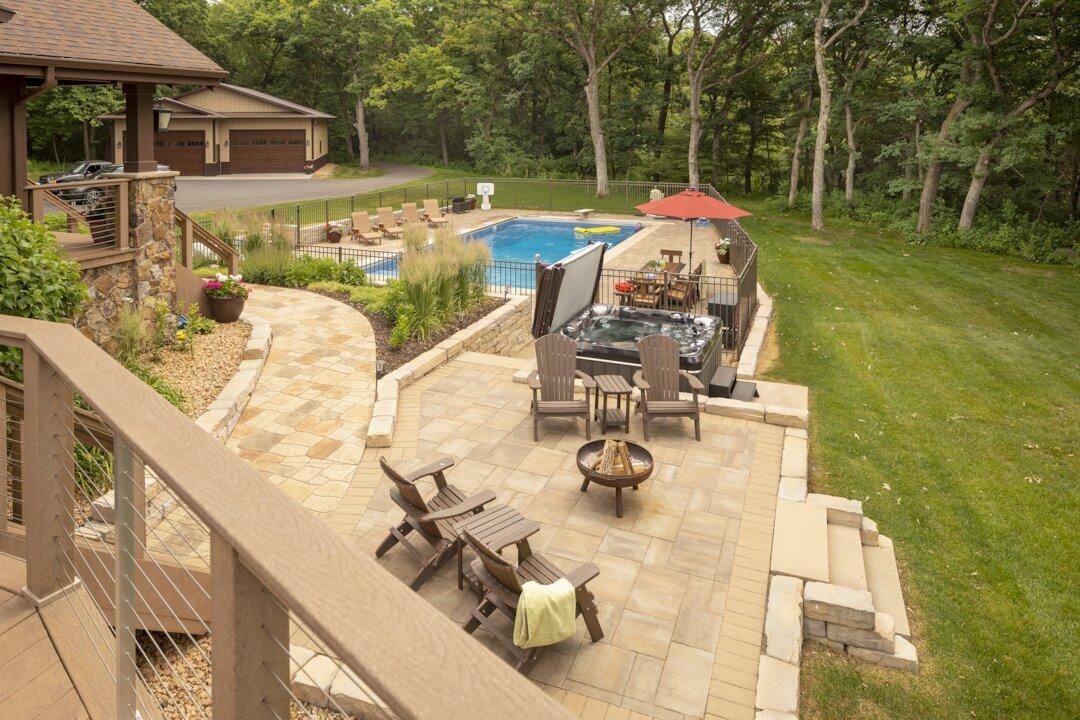 Front yard view featuring a fire patio, hot tub and fenced swimming pool