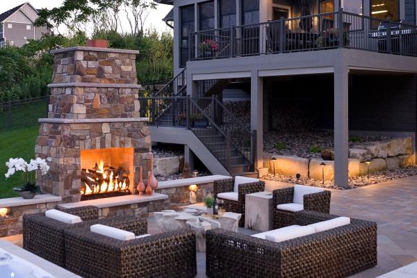 patio with a lit fireplace 