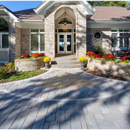 front entrance design with pavers and seasonal planters