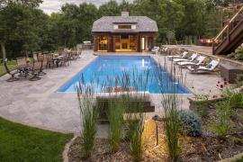 Pool house, hot tub, and natural stone patio and pool deck.