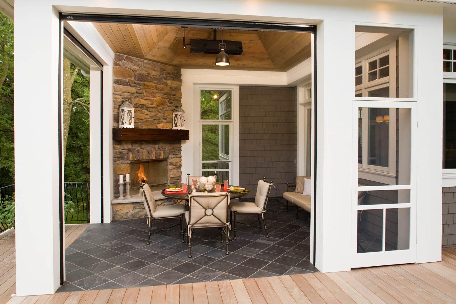 Three-season dining patio with tile floors, fireplace, and retractable screens