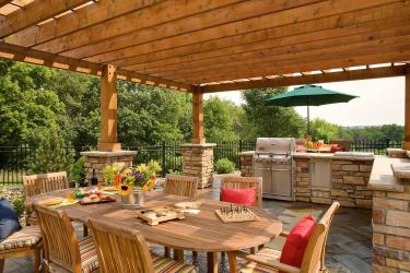 Outdoor kitchen and dining room under the pergola