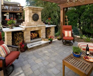 Pergola covers the entire patio in shade in this small backyard landscape in savage